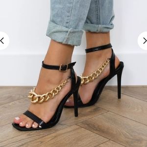 Black heels with chunky gold chain